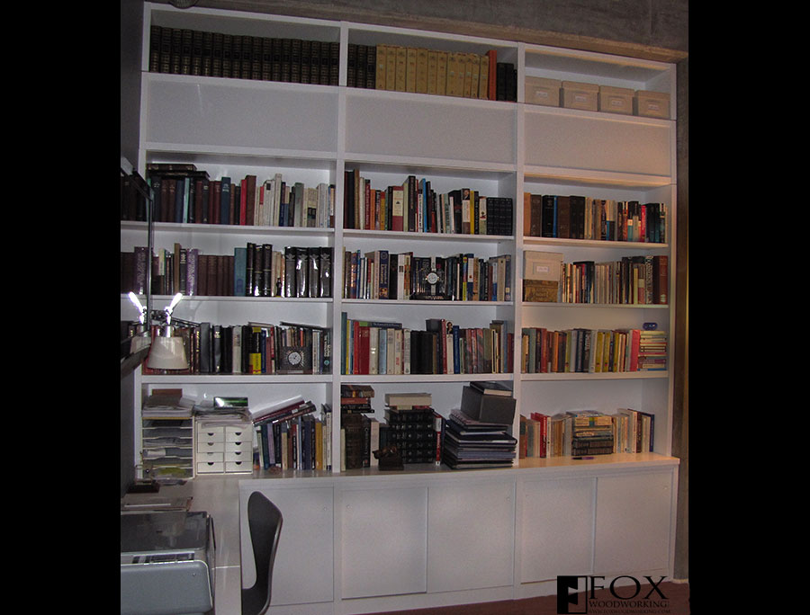 White bookcase with cabinets below.