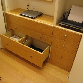 A birdseye maple closet desk with file drawer.