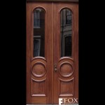 Unlike the mahogany patio doors, this pair of mahogany doors have arched and circular moldings.