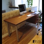 Besides the macassar ebony desk, we made a sapele desk with stainless steel legs and suspended drawers.