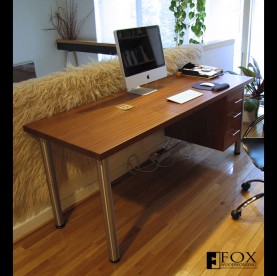 A sapele desk with stainless steel legs and suspended drawers.