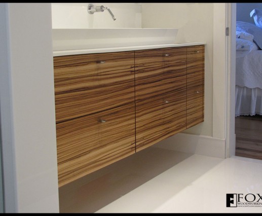A zebrawood veneer, multi-drawer vanity.