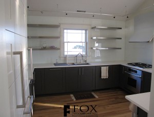 A great view of the floating stainless steel shelves and full height glass backsplash in Strathmere, NJ.