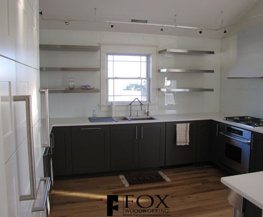 A great view of the floating stainless steel shelves and full height glass backsplash.