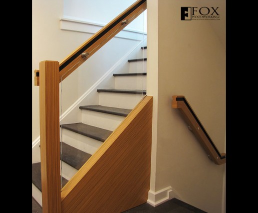 Teak veneered handrails and glass panel with stainless steel mounts.