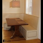 A breakfast nook eating area with bench storage.