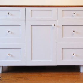 A painted six drawer vanity cabinet.