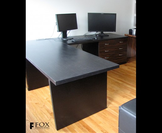 This desk is made with an ebony veneer top and macassar ebony door and drawer fronts.