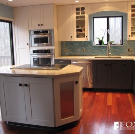 Painted cabinetry and stainless steel appliances and door panels.