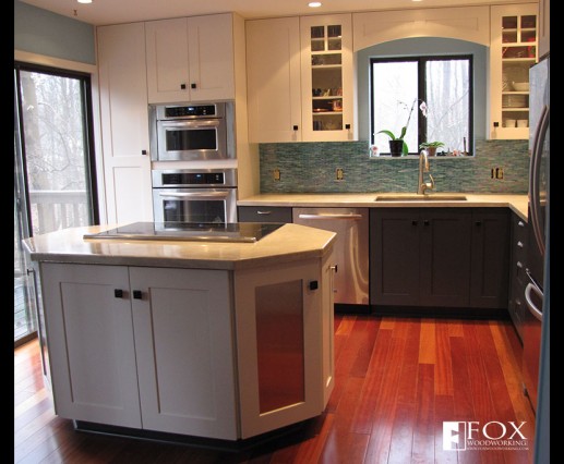 Painted cabinetry and stainless steel appliances and door panels.