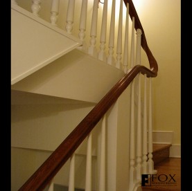 A removable sapele handrail and hand-carved downsweep.