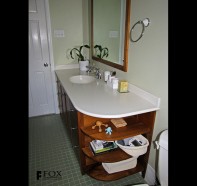 A Shaker-style, walnut vanity with white Corian top.