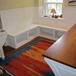 A view of the beadboard wainscot, bench seating, and storage in the alcove.
