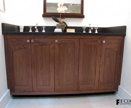A walnut vanity with arched rail doors and matched grain stiles.