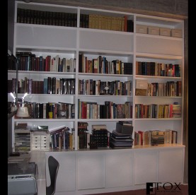 White bookcase with cabinets below.