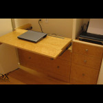 This birdseye maple desk creates plenty of workspace but stows away nicely into the closet to allow the room to be used for other purposes.