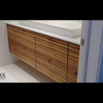 This zebrawood vanity can be found in Strathmere, NJ. The perfect graining creates a complete feel while the open space below creates a roomy appearance.