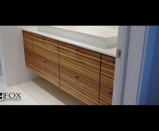 This zebrawood vanity can be found in Strathmere, NJ. The perfect graining creates a complete feel while the open space below creates a roomy appearance.